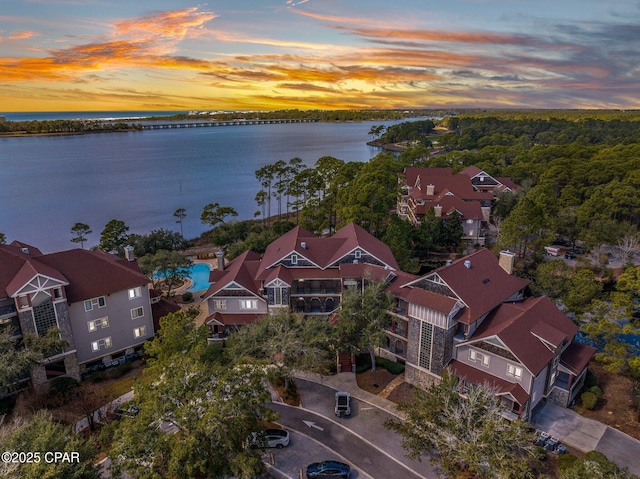 birds eye view of property featuring a water view and a residential view