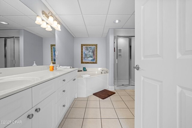 bathroom with plus walk in shower, vanity, tile patterned floors, and a drop ceiling