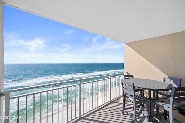 balcony with a view of the beach and a water view