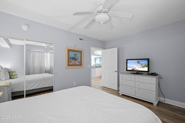 bedroom with ceiling fan and dark wood-type flooring