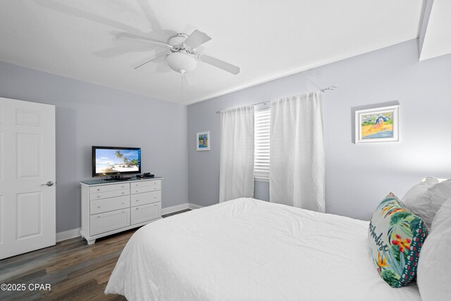 bedroom with ceiling fan and dark hardwood / wood-style flooring