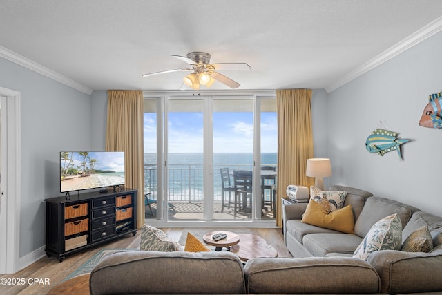 living room with hardwood / wood-style flooring, expansive windows, crown molding, and ceiling fan