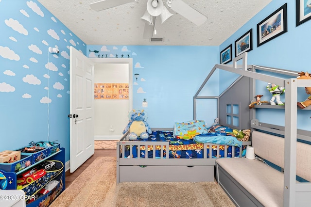 bedroom with a textured ceiling and ceiling fan