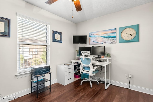 office area featuring a textured ceiling, ceiling fan, and dark wood-type flooring