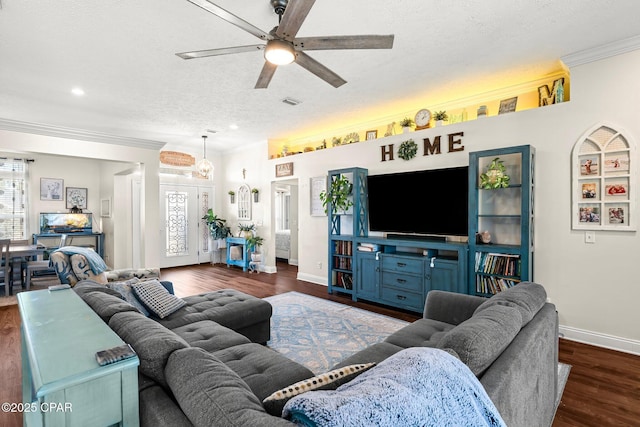 living room with dark hardwood / wood-style floors, ceiling fan, crown molding, and a textured ceiling