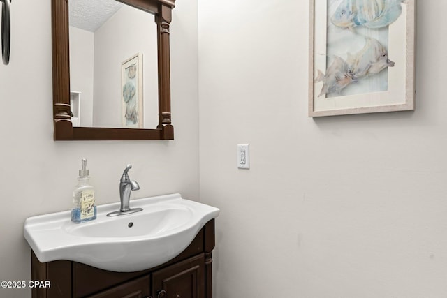 bathroom with vanity and a textured ceiling