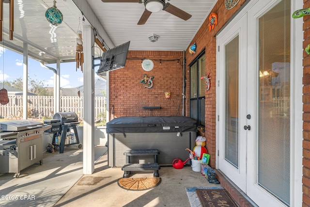 view of patio with ceiling fan, a hot tub, grilling area, and french doors