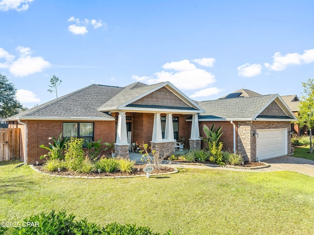 view of front facade with a front yard, a porch, and a garage