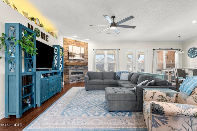 living room with ceiling fan, dark hardwood / wood-style flooring, and a textured ceiling