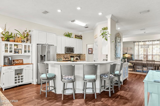 kitchen featuring white cabinets, a textured ceiling, and stainless steel appliances