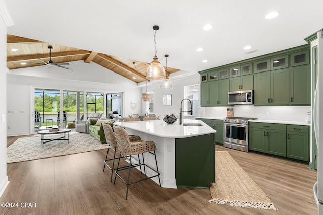 kitchen featuring appliances with stainless steel finishes, ceiling fan, pendant lighting, decorative backsplash, and green cabinets