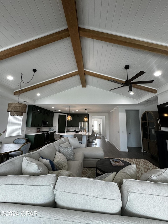 living room featuring ceiling fan, vaulted ceiling with beams, wood ceiling, and plenty of natural light