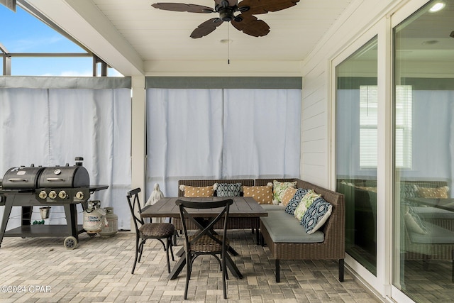 sunroom featuring ceiling fan