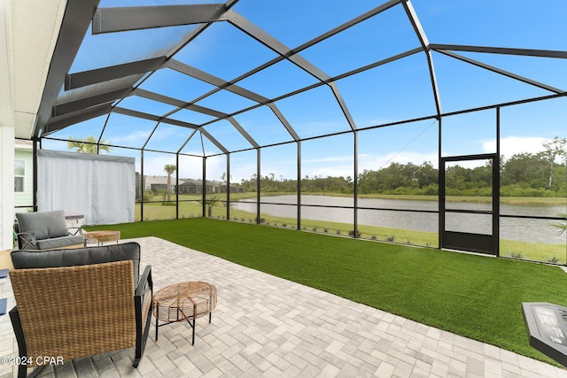 view of patio / terrace featuring glass enclosure and a water view