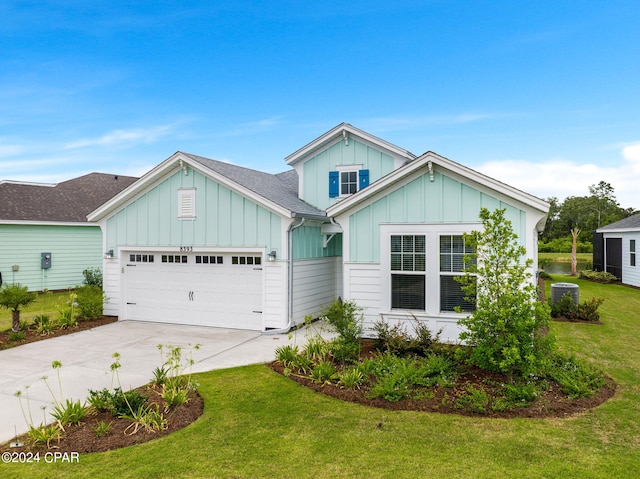 view of front of home featuring a front yard and a garage