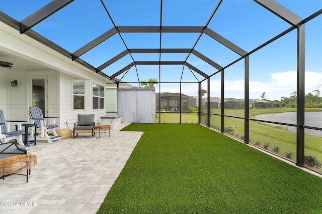 unfurnished sunroom featuring a water view