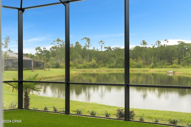 unfurnished sunroom featuring a water view