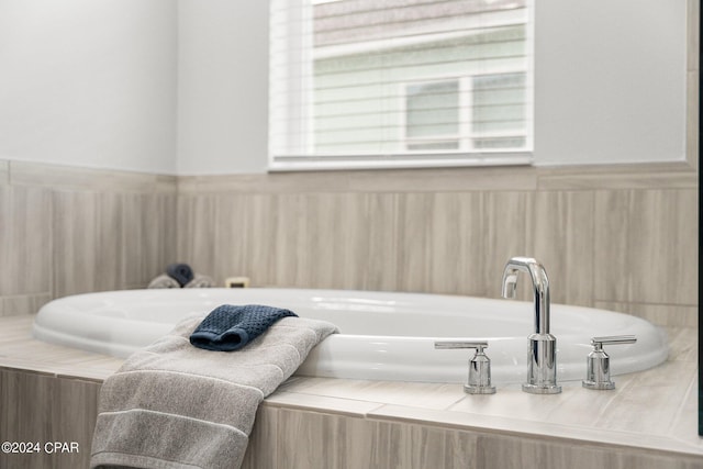 bathroom featuring a relaxing tiled tub