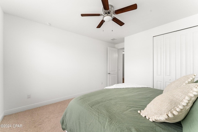 bedroom featuring a closet, ceiling fan, and carpet