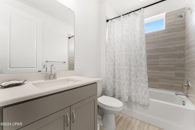 full bathroom with toilet, wood-type flooring, vanity, and shower / bath combo