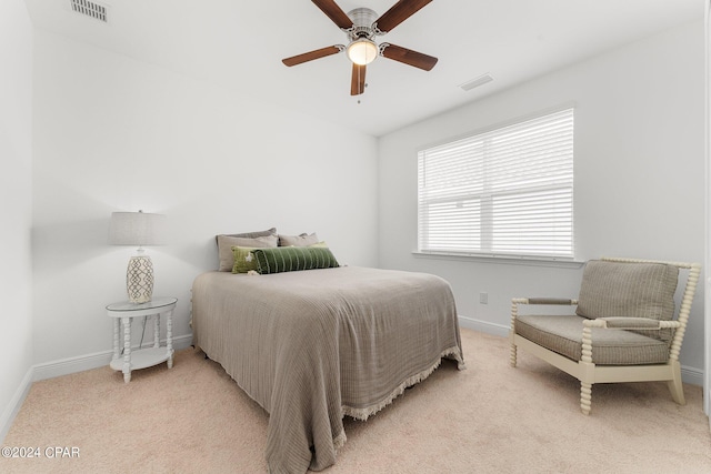 bedroom featuring light carpet and ceiling fan