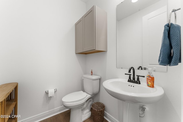 bathroom with toilet and hardwood / wood-style floors