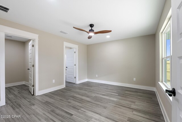 bathroom featuring hardwood / wood-style flooring, vanity, and walk in shower