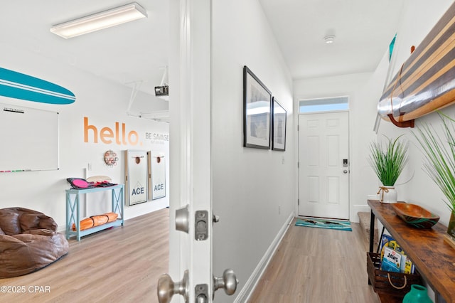 corridor with light hardwood / wood-style floors