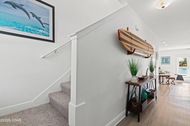 staircase with hardwood / wood-style flooring