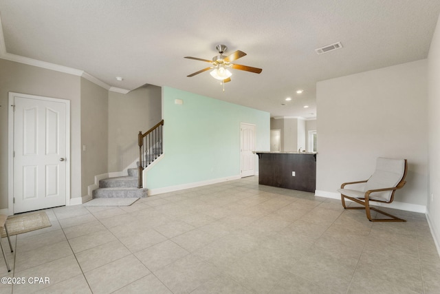 unfurnished room with ceiling fan and ornamental molding