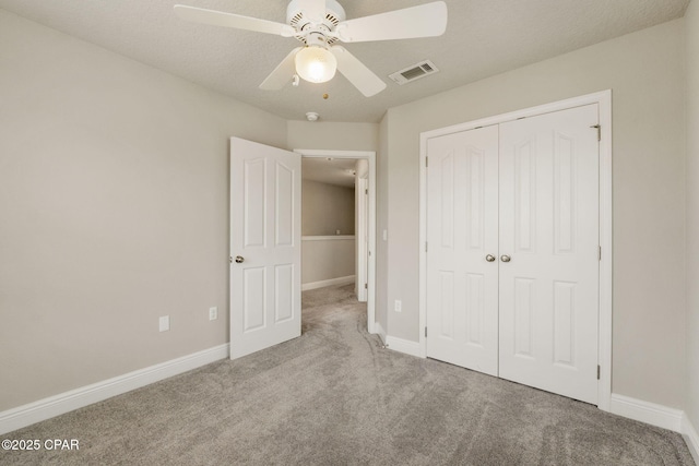 unfurnished bedroom featuring light carpet, ceiling fan, and a closet