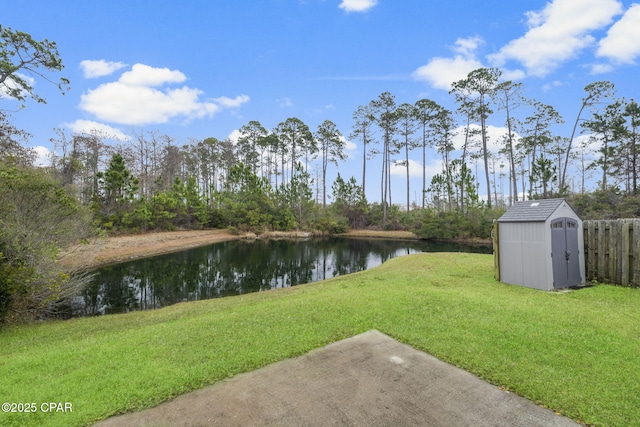 view of yard featuring a storage shed and a water view