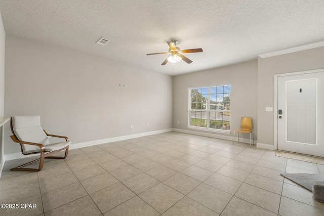 foyer entrance featuring light tile patterned floors, a textured ceiling, and ceiling fan