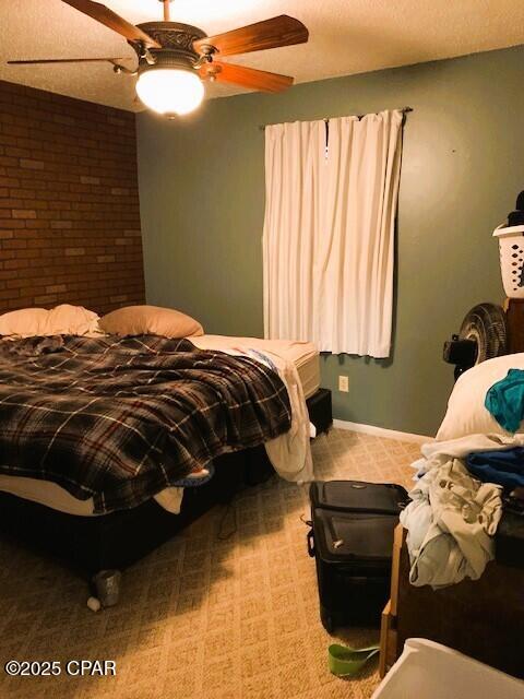 bedroom featuring a textured ceiling, ceiling fan, and carpet flooring