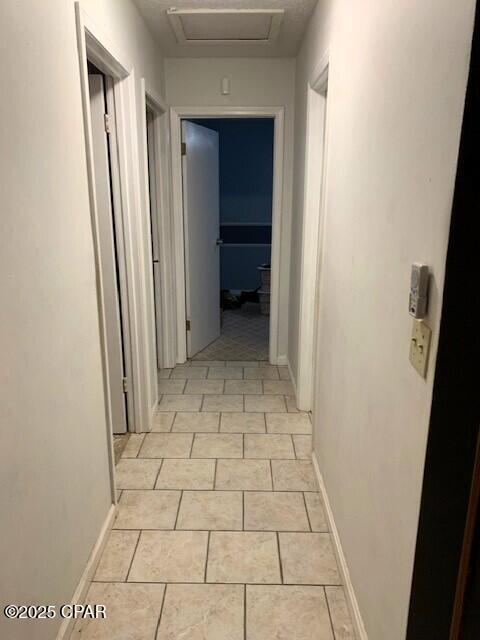 hallway with light tile patterned floors