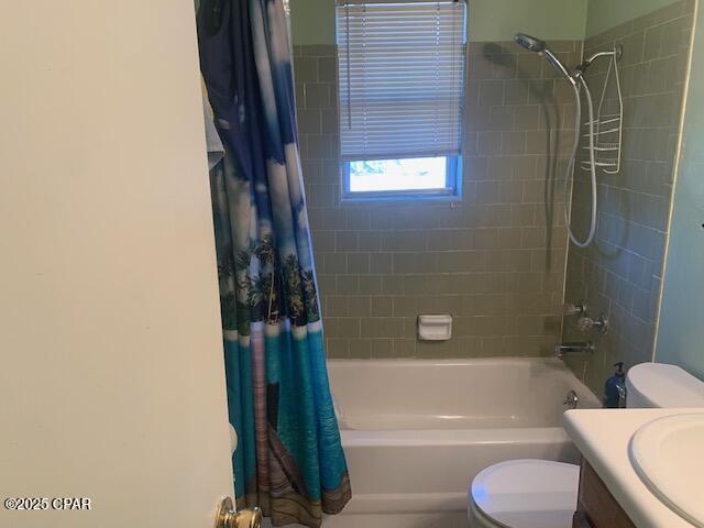 full bathroom with shower / bath combination with curtain, vanity, and toilet