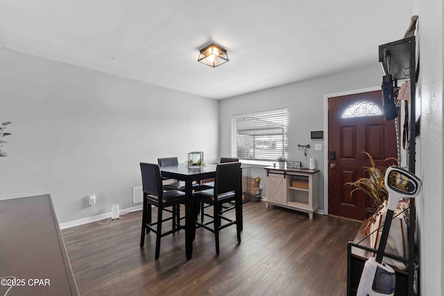 dining space with dark wood-style flooring and baseboards