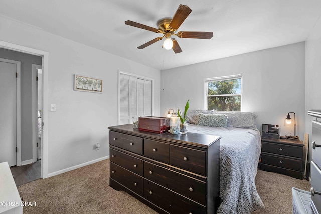 bedroom with a closet, carpet flooring, a ceiling fan, and baseboards