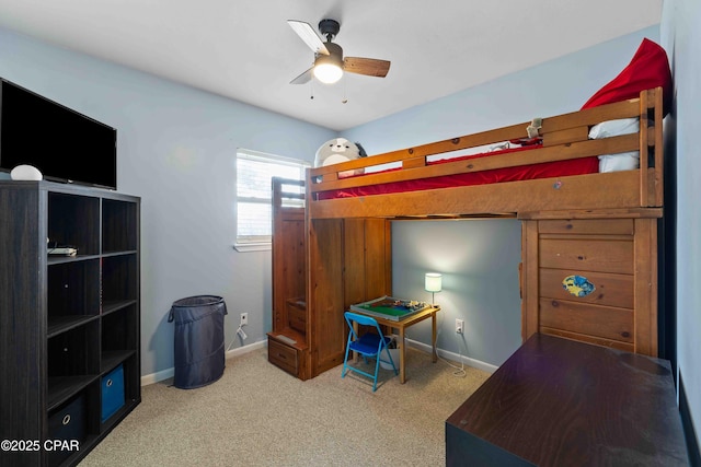 bedroom with a ceiling fan, carpet flooring, and baseboards