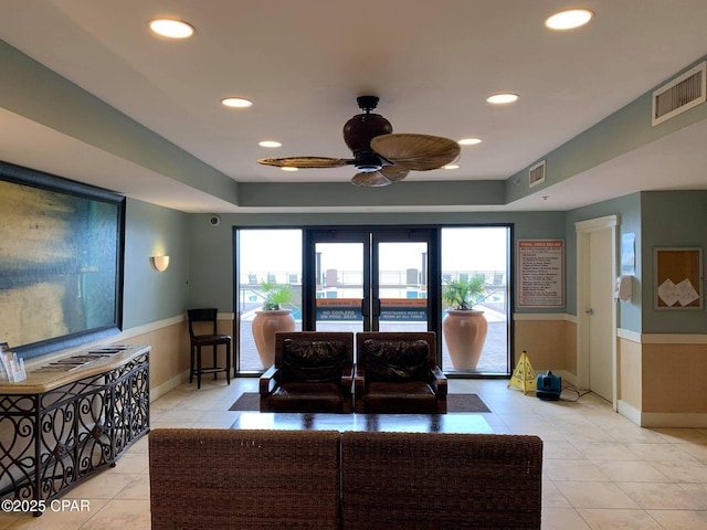 tiled living room featuring french doors and ceiling fan