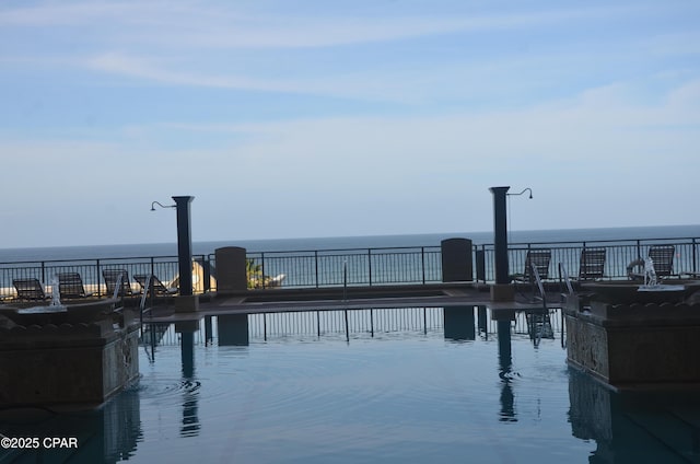 view of swimming pool featuring a water view