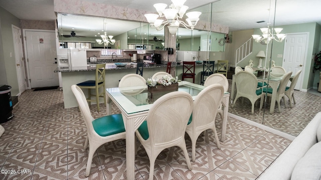 dining space with ceiling fan and sink