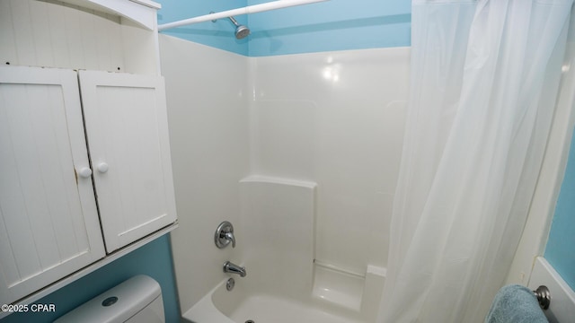 bathroom with shower / tub combo and toilet