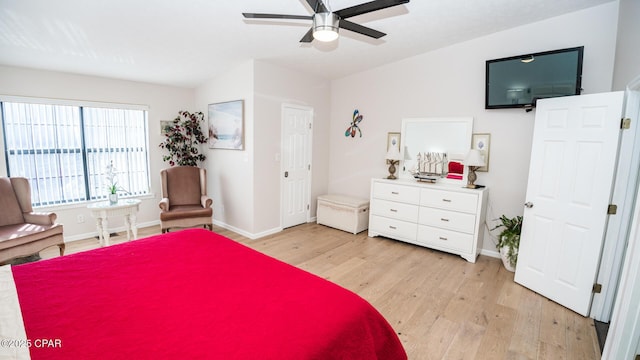 bedroom featuring ceiling fan, light hardwood / wood-style floors, and lofted ceiling