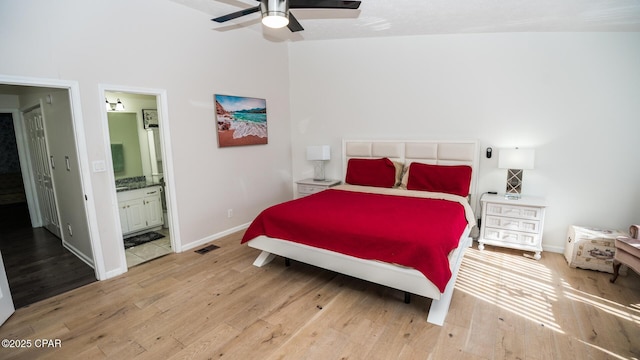 bedroom with ensuite bathroom, light hardwood / wood-style flooring, and ceiling fan