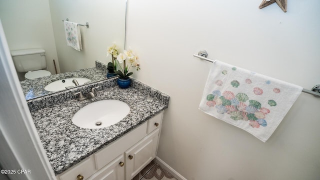 bathroom featuring vanity and toilet