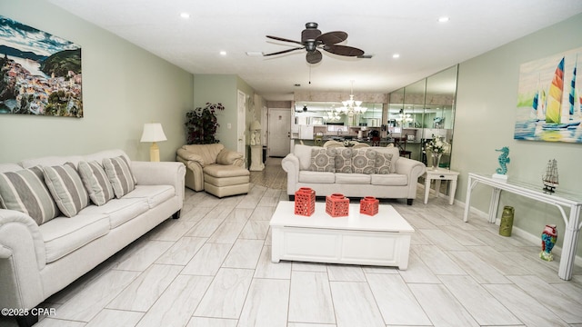 living room with ceiling fan with notable chandelier