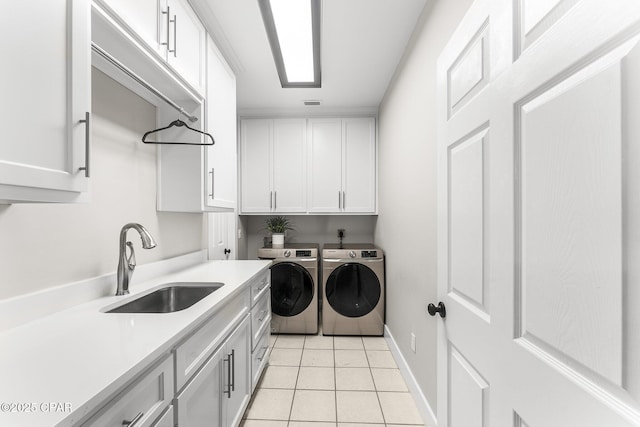 laundry room featuring washer and dryer, light tile patterned floors, sink, and cabinets