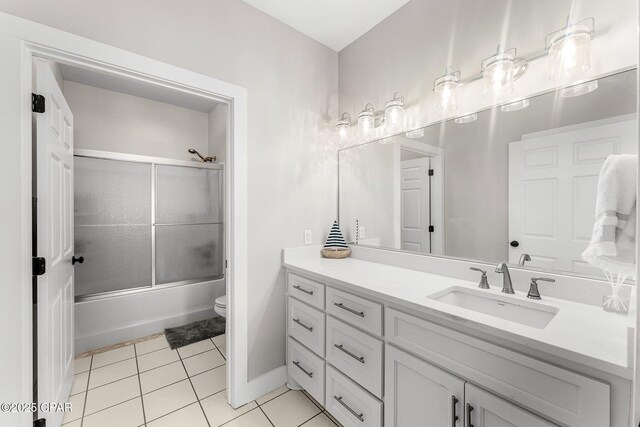 full bathroom featuring combined bath / shower with glass door, vanity, toilet, and tile patterned flooring