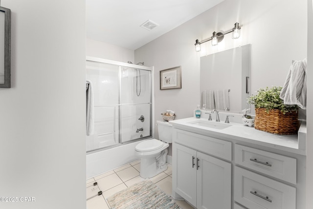 full bathroom featuring shower / bath combination with glass door, vanity, toilet, and tile patterned flooring